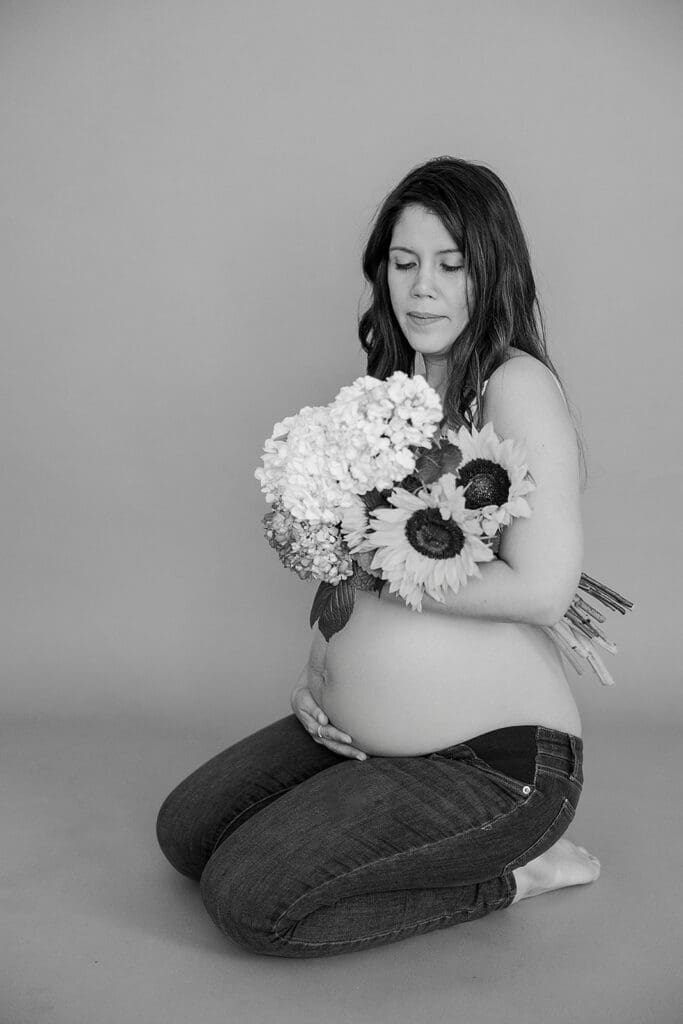 Studio maternity photography in Richmond showing the Holguins with flowers, ultrasound pictures and simple elegant backdrops.