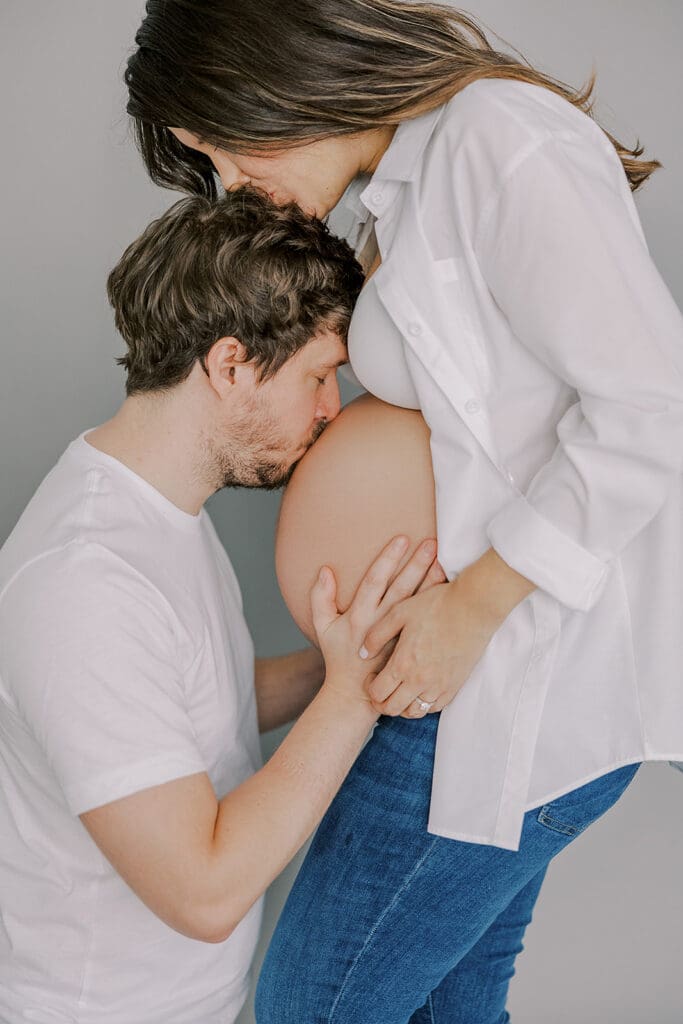 Studio maternity photography in Richmond showing the Holguins with flowers, ultrasound pictures and simple elegant backdrops.