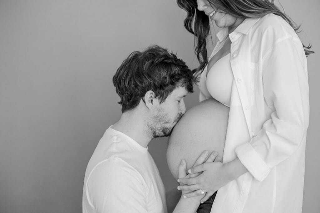 Studio maternity photography in Richmond showing the Holguins with flowers, ultrasound pictures and simple elegant backdrops.