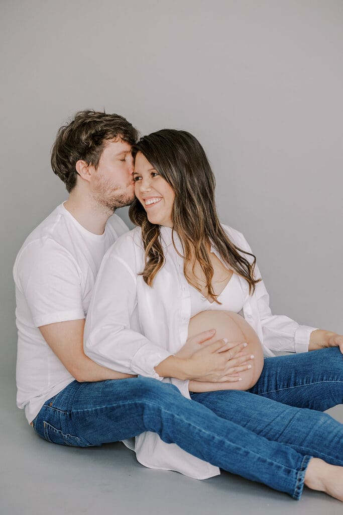 Studio maternity photography in Richmond showing the Holguins with flowers, ultrasound pictures and simple elegant backdrops.