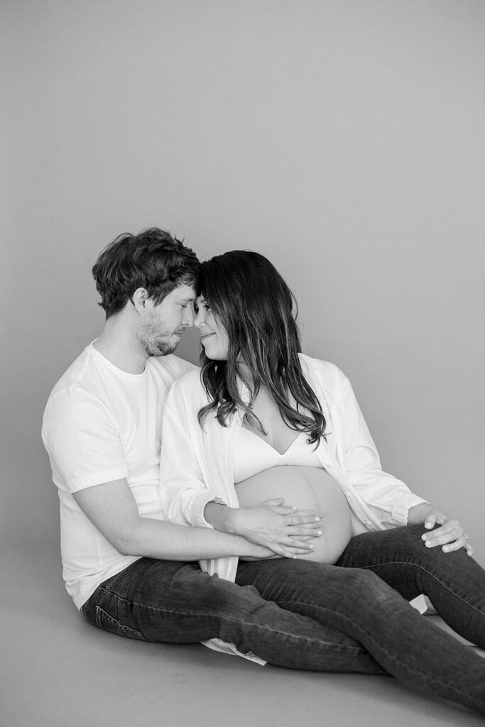 Studio maternity photography in Richmond showing the Holguins with flowers, ultrasound pictures and simple elegant backdrops.