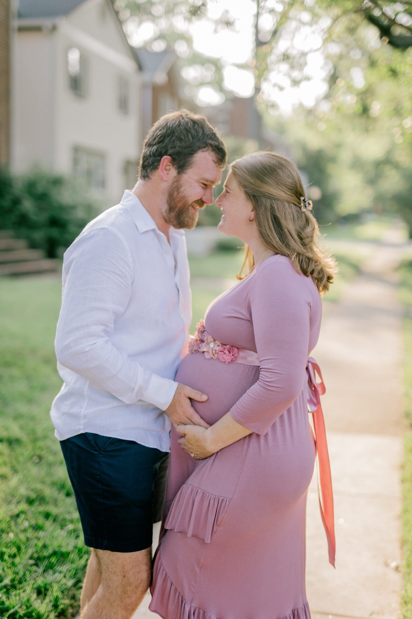 A pregnant woman and her husband pose during their Richmond maternity session.