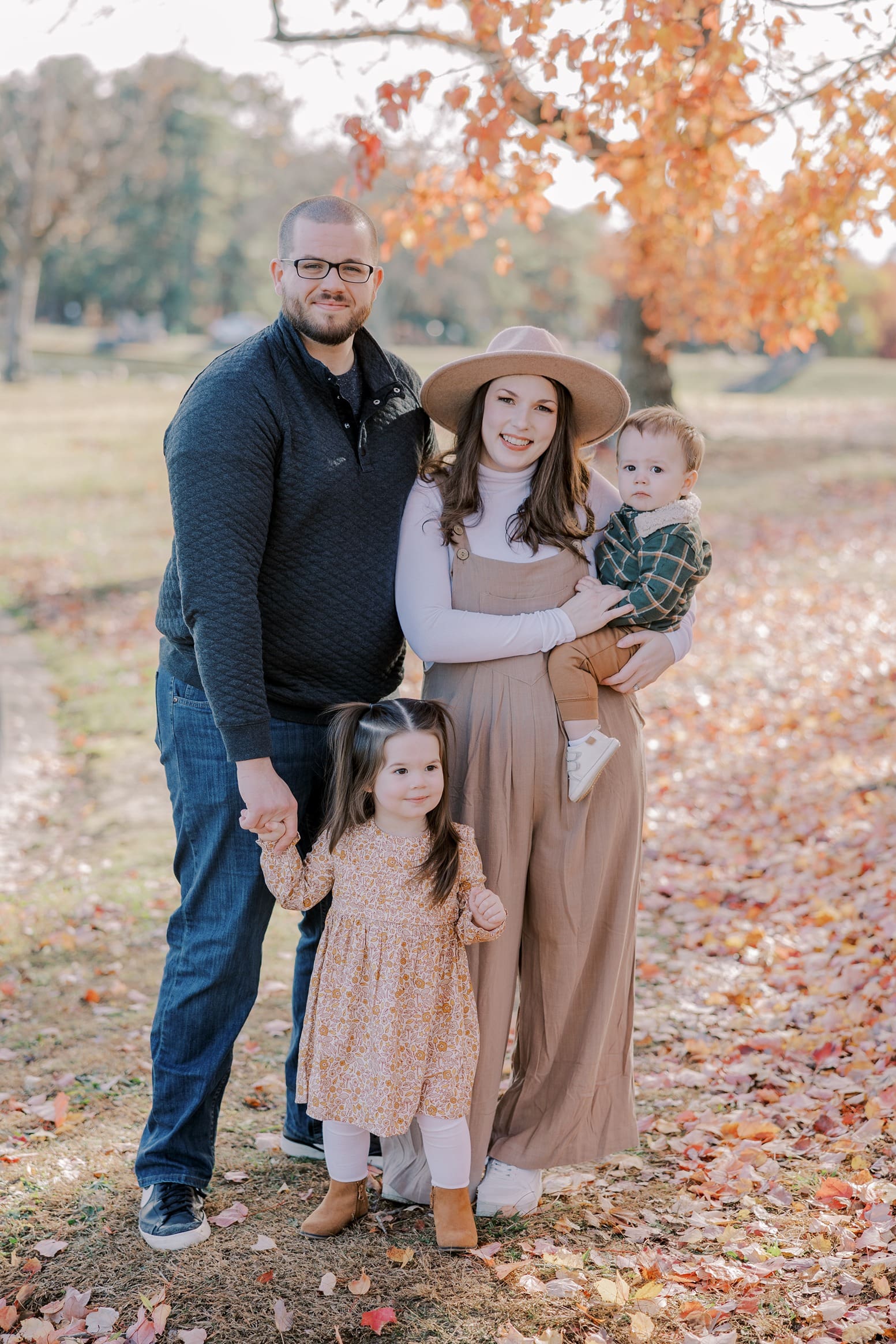 A family poses during their portrait session a perfect Richmond family outfit.