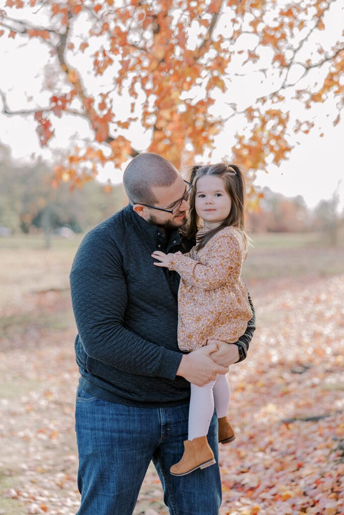 Richmond fall family photography session with the Keeley family surrounded by orange autumn leaves at Byrd Park.