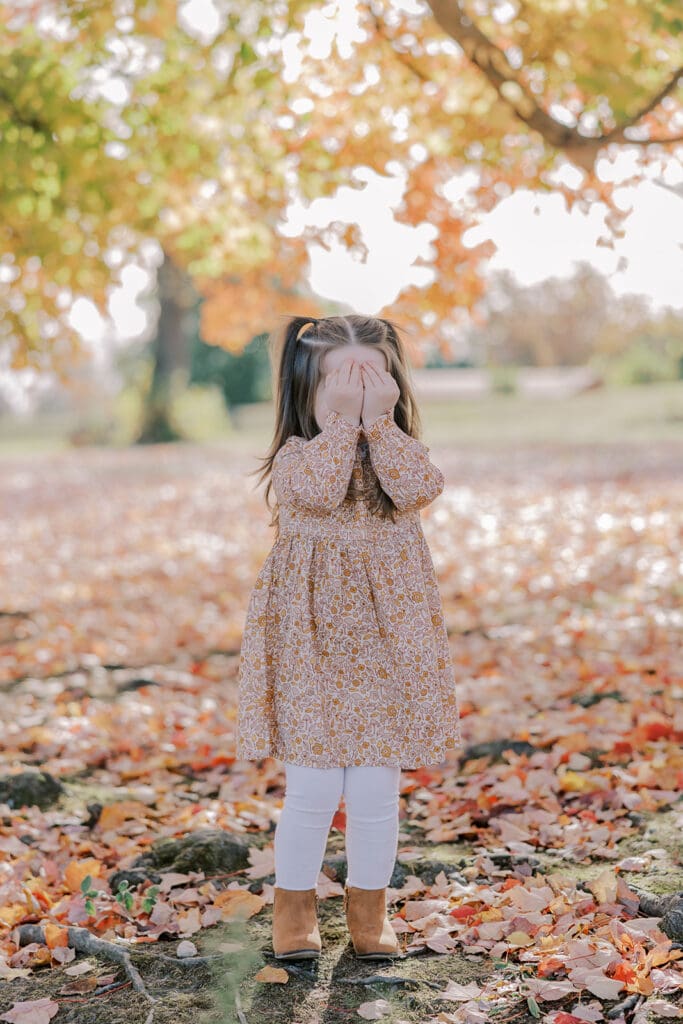 Richmond fall family photography session with the Keeley family surrounded by orange autumn leaves at Byrd Park.