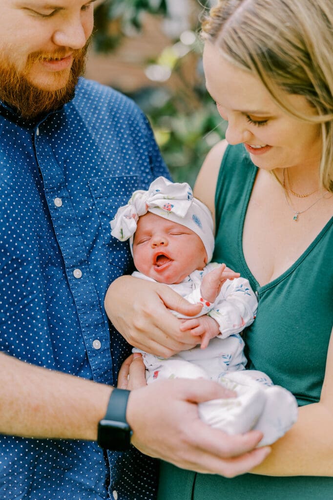 Richmond lifestyle newborn photographer session showing the Quick family with their new baby girl in their home.