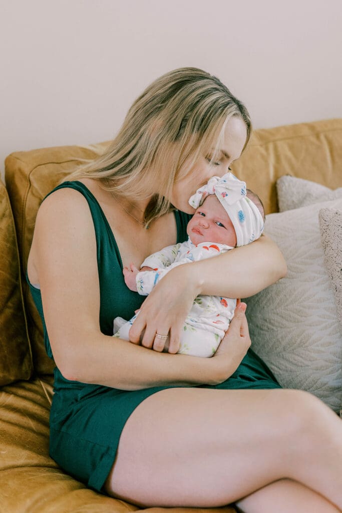 Richmond lifestyle newborn photographer session showing the Quick family with their new baby girl in their home.