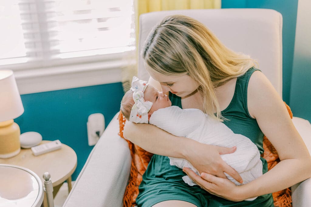 Richmond lifestyle newborn photographer session showing the Quick family with their new baby girl in their home.