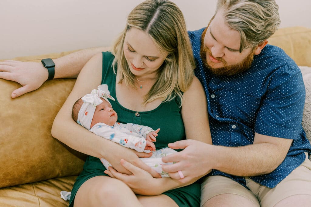 Richmond lifestyle newborn photographer session showing the Quick family with their new baby girl in their home.