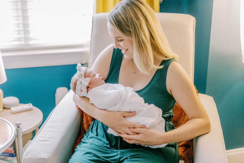 Richmond lifestyle newborn photographer session showing the Quick family with their new baby girl in their home.