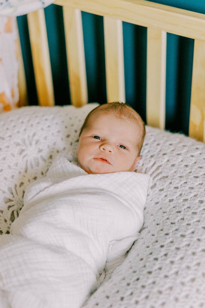 Richmond lifestyle newborn photographer session showing the Quick family with their new baby girl in their home.