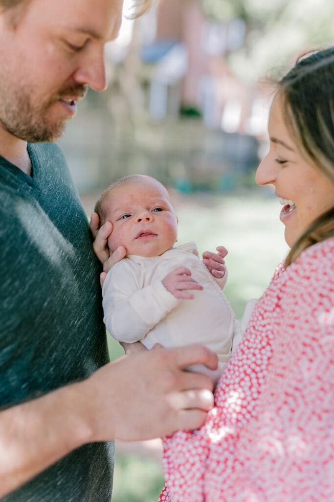 Richmond in-home lifestyle newborn session showing the Roost family with their baby in a purple-themed nursery and outdoor spring portraits.