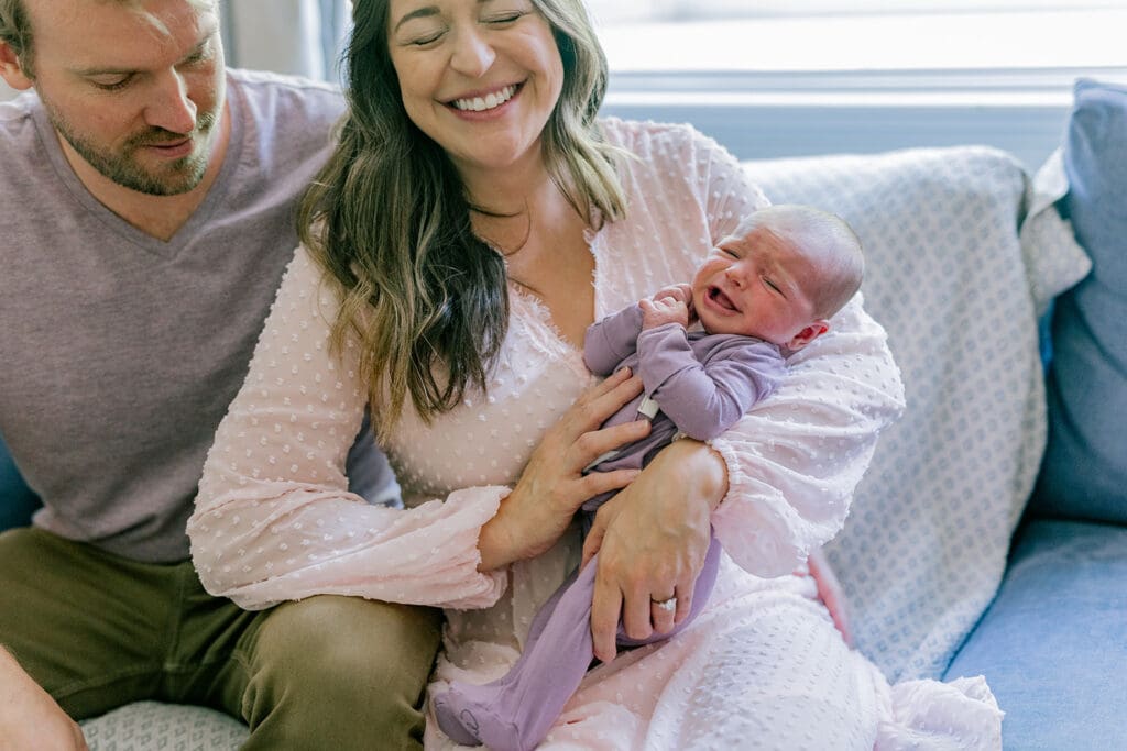 Richmond in-home lifestyle newborn session showing the Roost family with their baby in a purple-themed nursery and outdoor spring portraits.