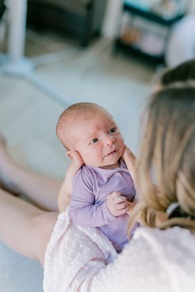 Richmond in-home lifestyle newborn session showing the Roost family with their baby in a purple-themed nursery and outdoor spring portraits.