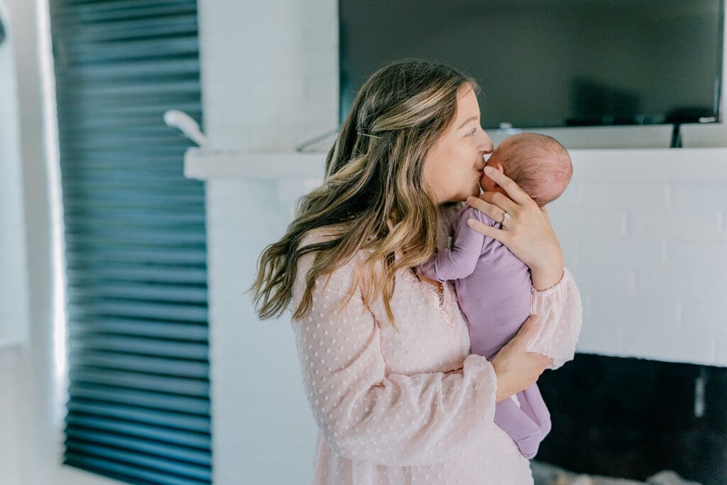 Richmond in-home lifestyle newborn session showing the Roost family with their baby in a purple-themed nursery and outdoor spring portraits.