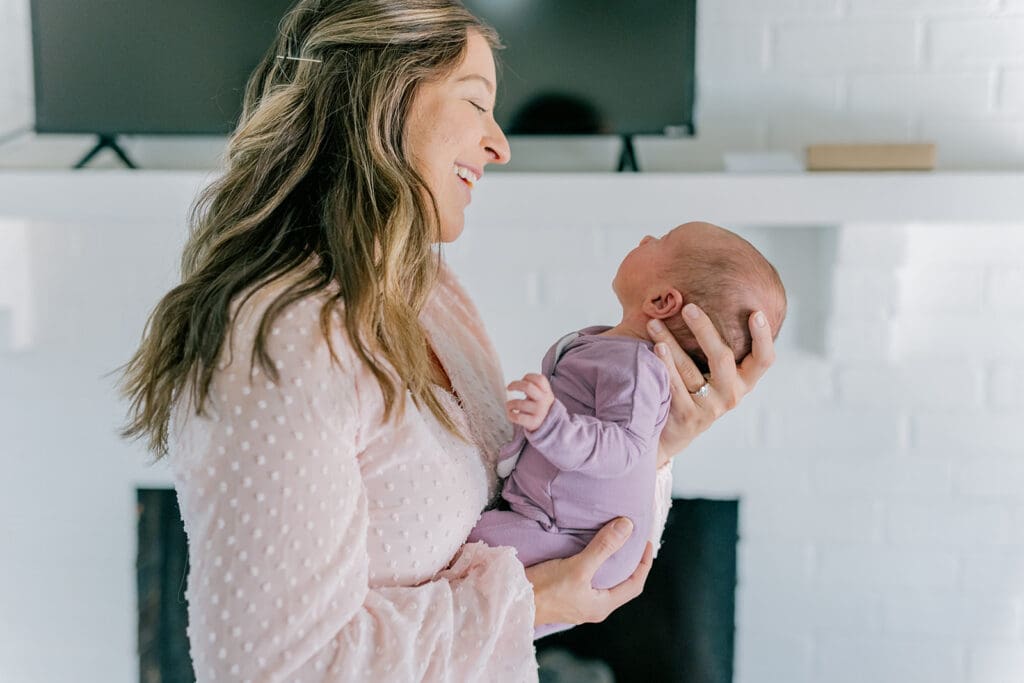 Richmond in-home lifestyle newborn session showing the Roost family with their baby in a purple-themed nursery and outdoor spring portraits.