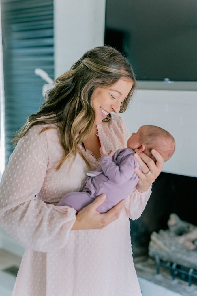 Richmond in-home lifestyle newborn session showing the Roost family with their baby in a purple-themed nursery and outdoor spring portraits.