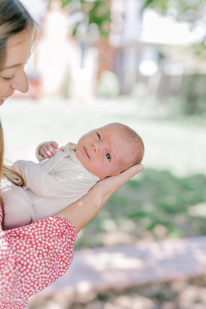 Richmond in-home lifestyle newborn session showing the Roost family with their baby in a purple-themed nursery and outdoor spring portraits.