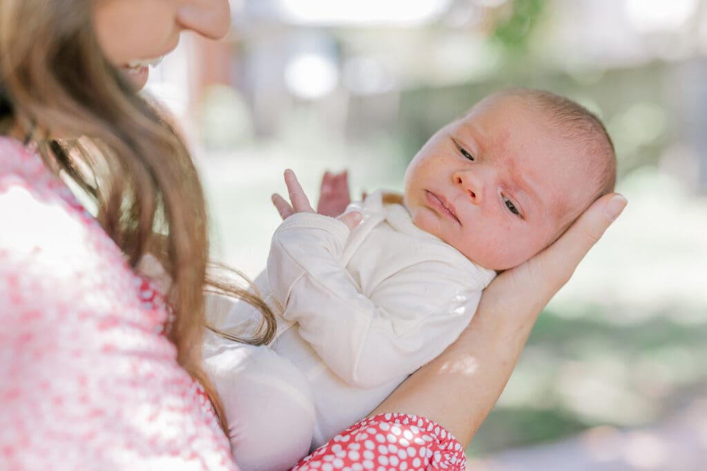 Richmond in-home lifestyle newborn session showing the Roost family with their baby in a purple-themed nursery and outdoor spring portraits.