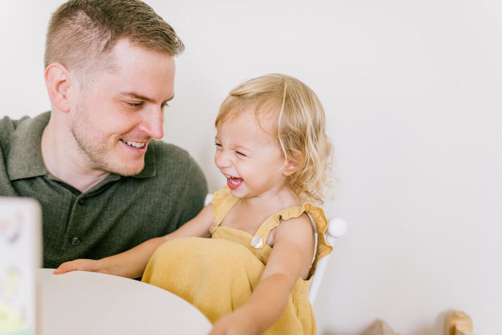 Lifestyle family photographer in Richmond documenting the Allred family reading, playing, dancing and snuggling in coordinated outfits.