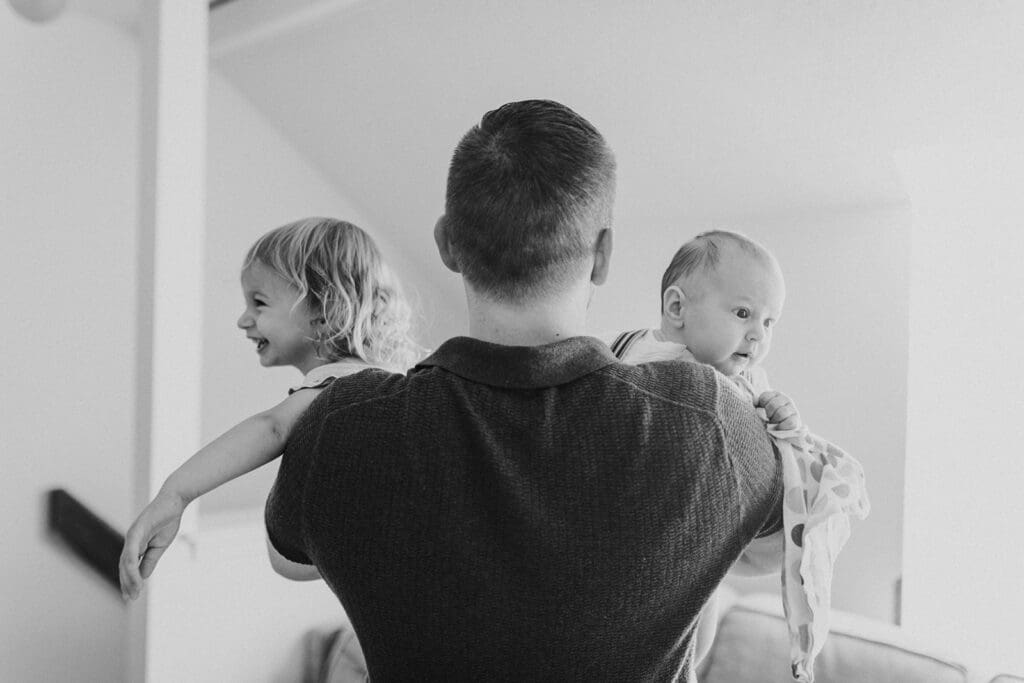 Lifestyle family photographer in Richmond documenting the Allred family reading, playing, dancing and snuggling in coordinated outfits.