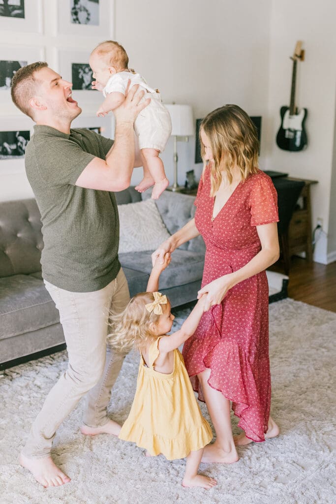 Lifestyle family photographer in Richmond documenting the Allred family reading, playing, dancing and snuggling in coordinated outfits.