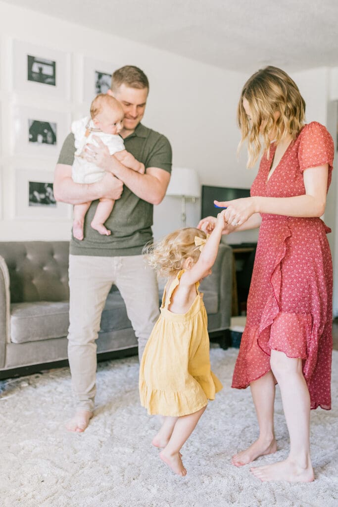 Lifestyle family photographer in Richmond documenting the Allred family reading, playing, dancing and snuggling in coordinated outfits.