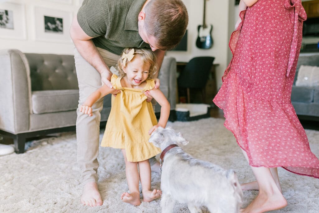 Lifestyle family photographer in Richmond documenting the Allred family reading, playing, dancing and snuggling in coordinated outfits.