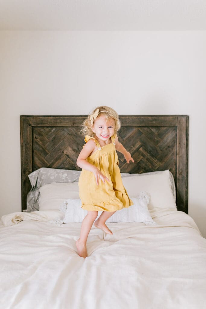 Lifestyle family photographer in Richmond documenting the Allred family reading, playing, dancing and snuggling in coordinated outfits.