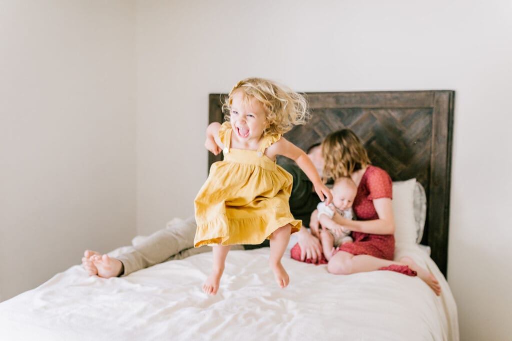 Lifestyle family photographer in Richmond documenting the Allred family reading, playing, dancing and snuggling in coordinated outfits.