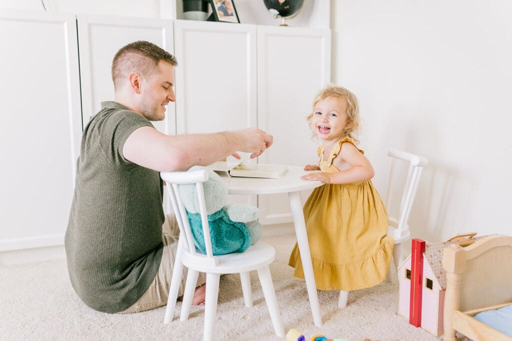 Lifestyle family photographer in Richmond documenting the Allred family reading, playing, dancing and snuggling in coordinated outfits.