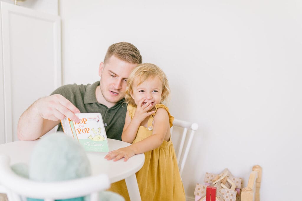 Lifestyle family photographer in Richmond documenting the Allred family reading, playing, dancing and snuggling in coordinated outfits.