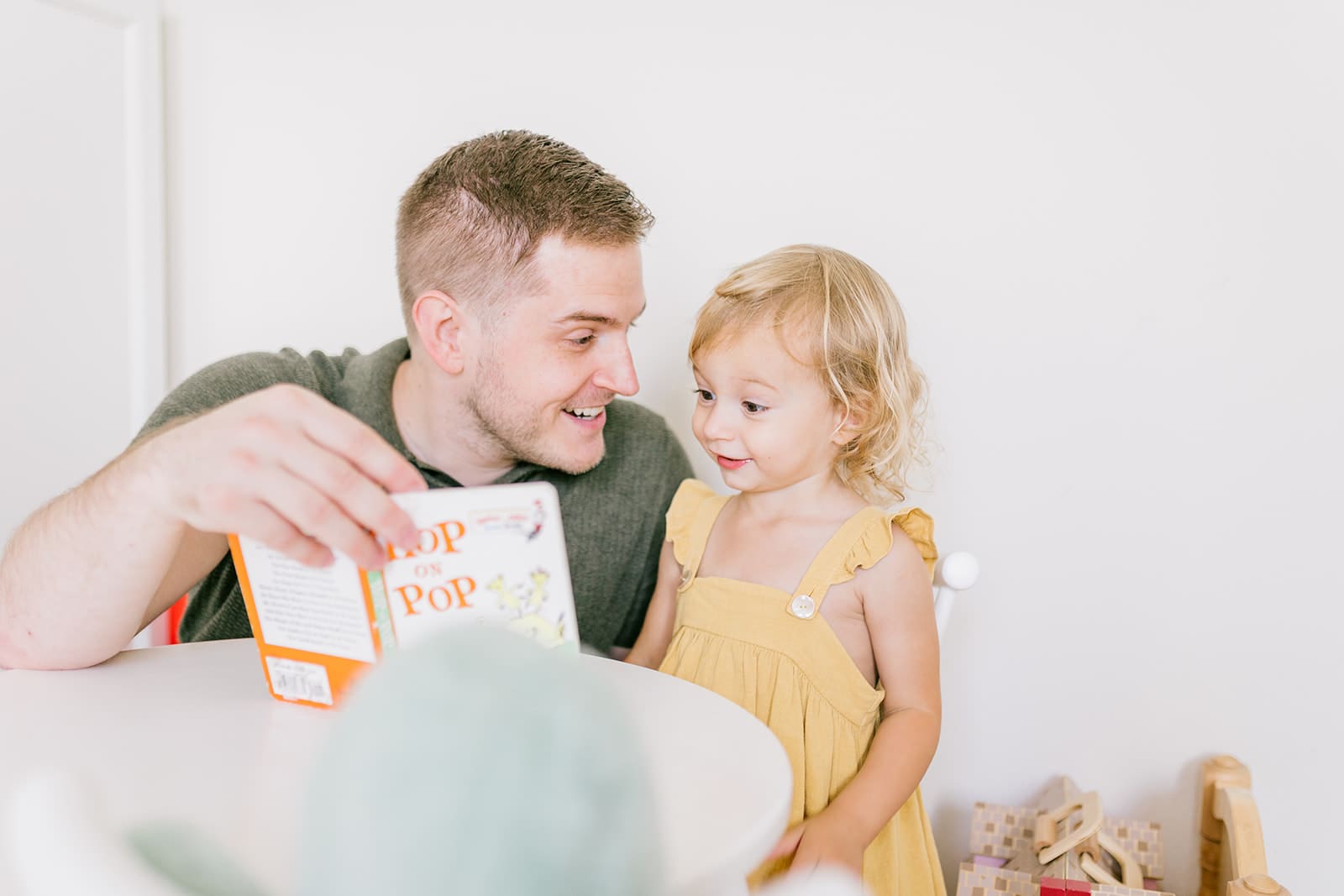 Lifestyle family photographer in Richmond documenting the Allred family reading, playing, dancing and snuggling in coordinated outfits.