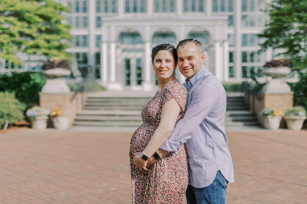 Lewis Ginter maternity photography session featuring the Mertz family surrounded by spring blooms in the botanical gardens.