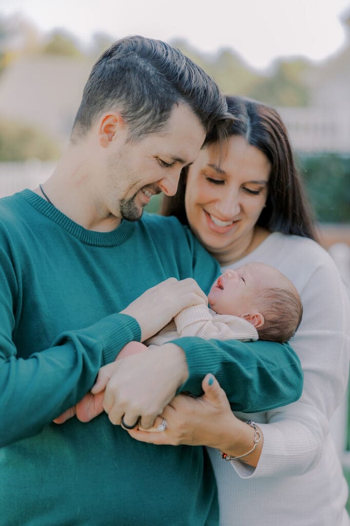 Lifestyle newborn photography in Richmond session showing the Barnes family with baby Lincoln in their home and backyard.