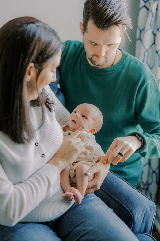 Lifestyle newborn photography in Richmond session showing the Barnes family with baby Lincoln in their home and backyard.