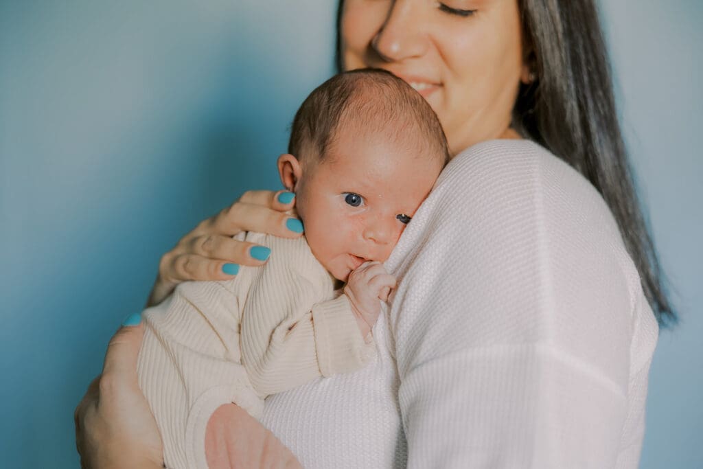 Lifestyle newborn photography in Richmond session showing the Barnes family with baby Lincoln in their home and backyard.