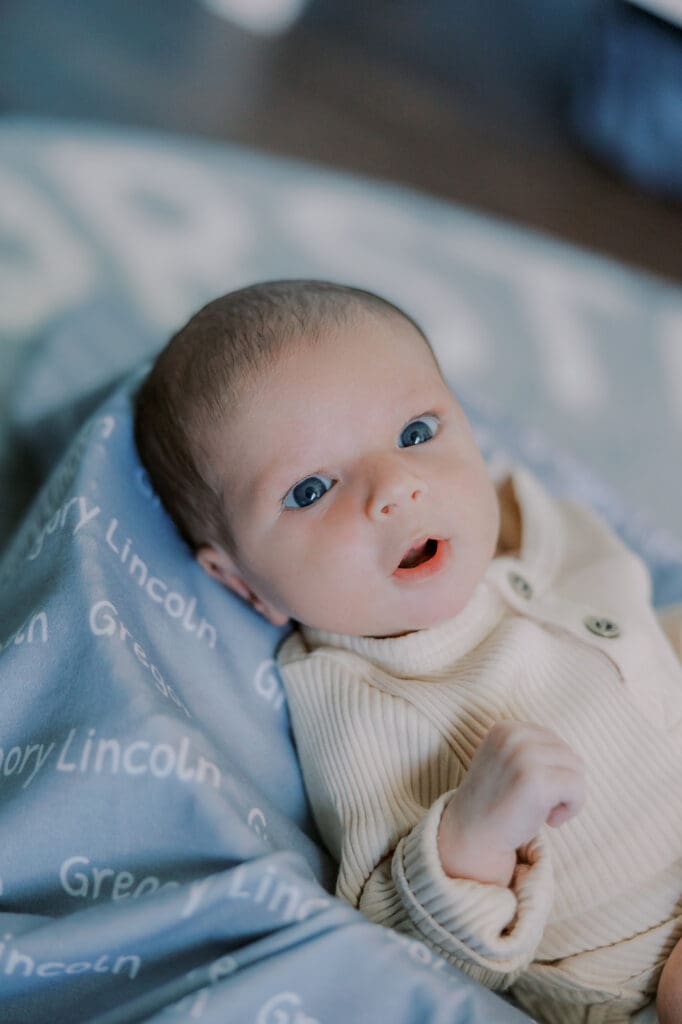 Lifestyle newborn photography in Richmond session showing the Barnes family with baby Lincoln in their home and backyard.