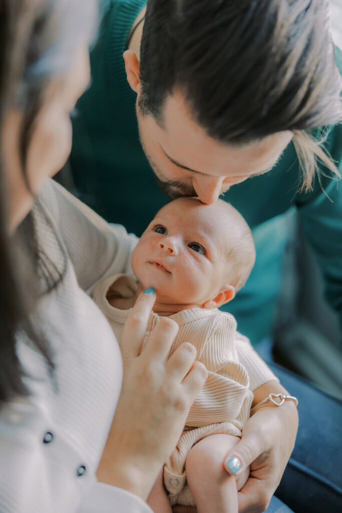 Lifestyle newborn photography in Richmond session showing the Barnes family with baby Lincoln in their home and backyard.