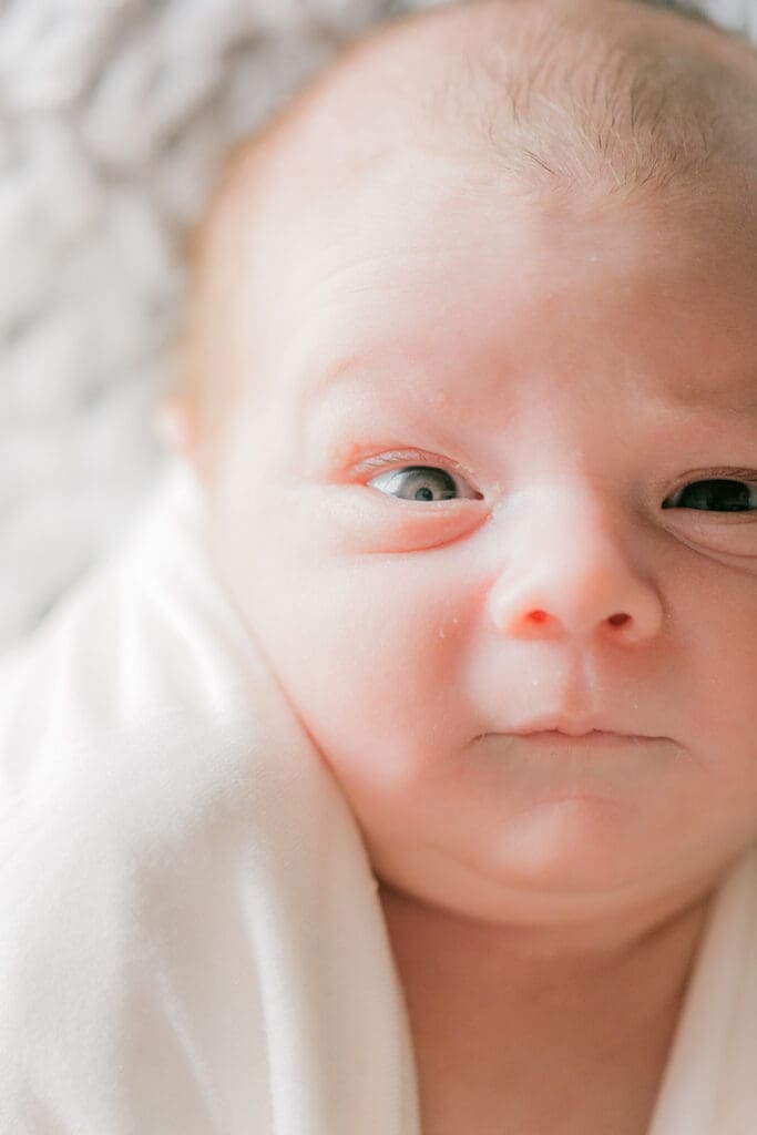 Hampton Roads newborn photography session featuring Baby Caeden in simple white setups with crate and bucket props.