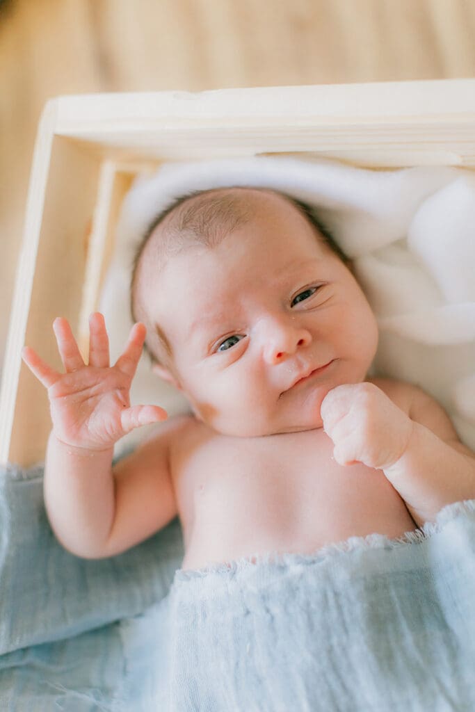 Hampton Roads newborn photography session featuring Baby Caeden in simple white setups with crate and bucket props.