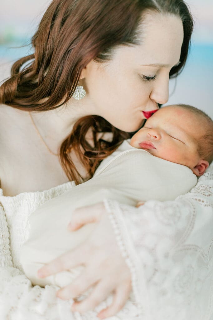 Baby Ember poses with mom during her in-home newborn photography session.