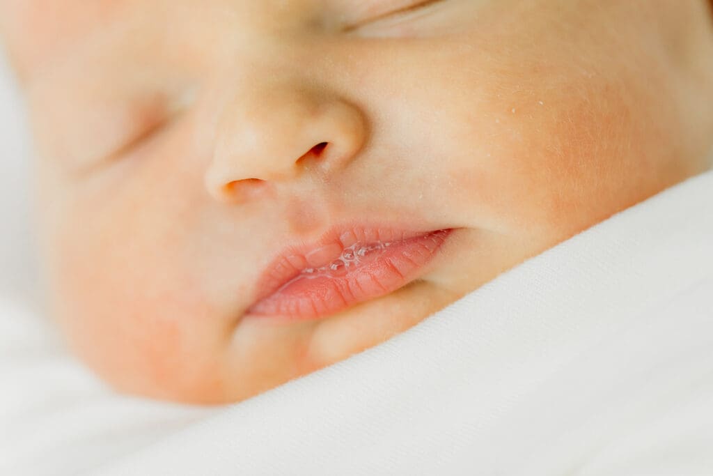 Baby Ember has cute lips during her in-home newborn photography session.