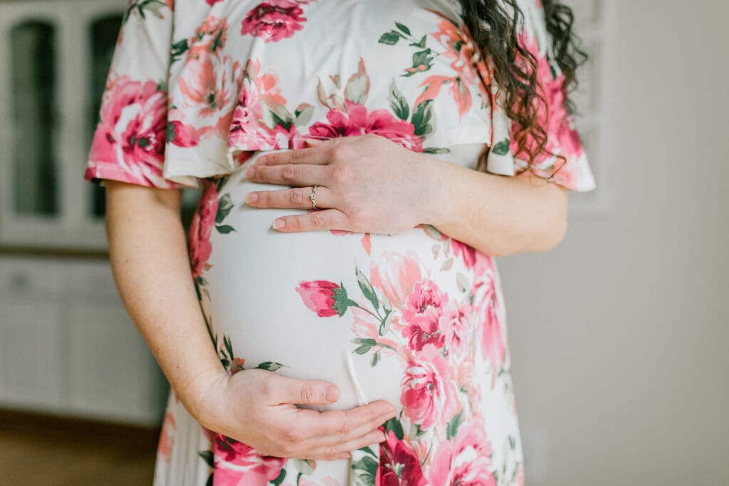 March maternity session in Williamsburg featuring the Sabo family in their cozy home and baby's nursery.