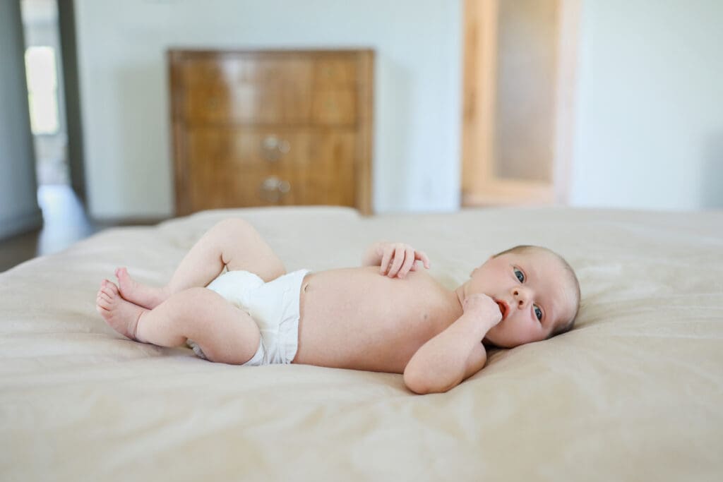 Richmond newborn photographer session featuring baby Cooper and his family in their sunlit Rockville home with their dog Riley