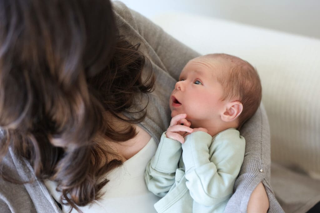 Richmond newborn photographer session featuring baby Cooper and his family in their sunlit Rockville home with their dog Riley